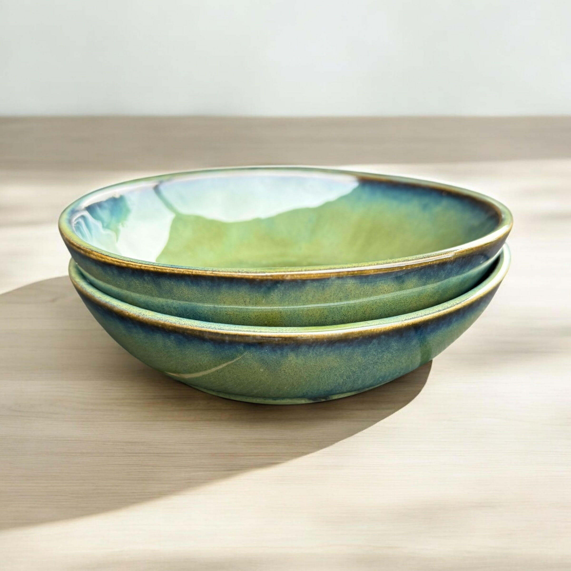 Handmade bowl set with flowing green and blue hues, ideal for serving salads or as decorative accents.