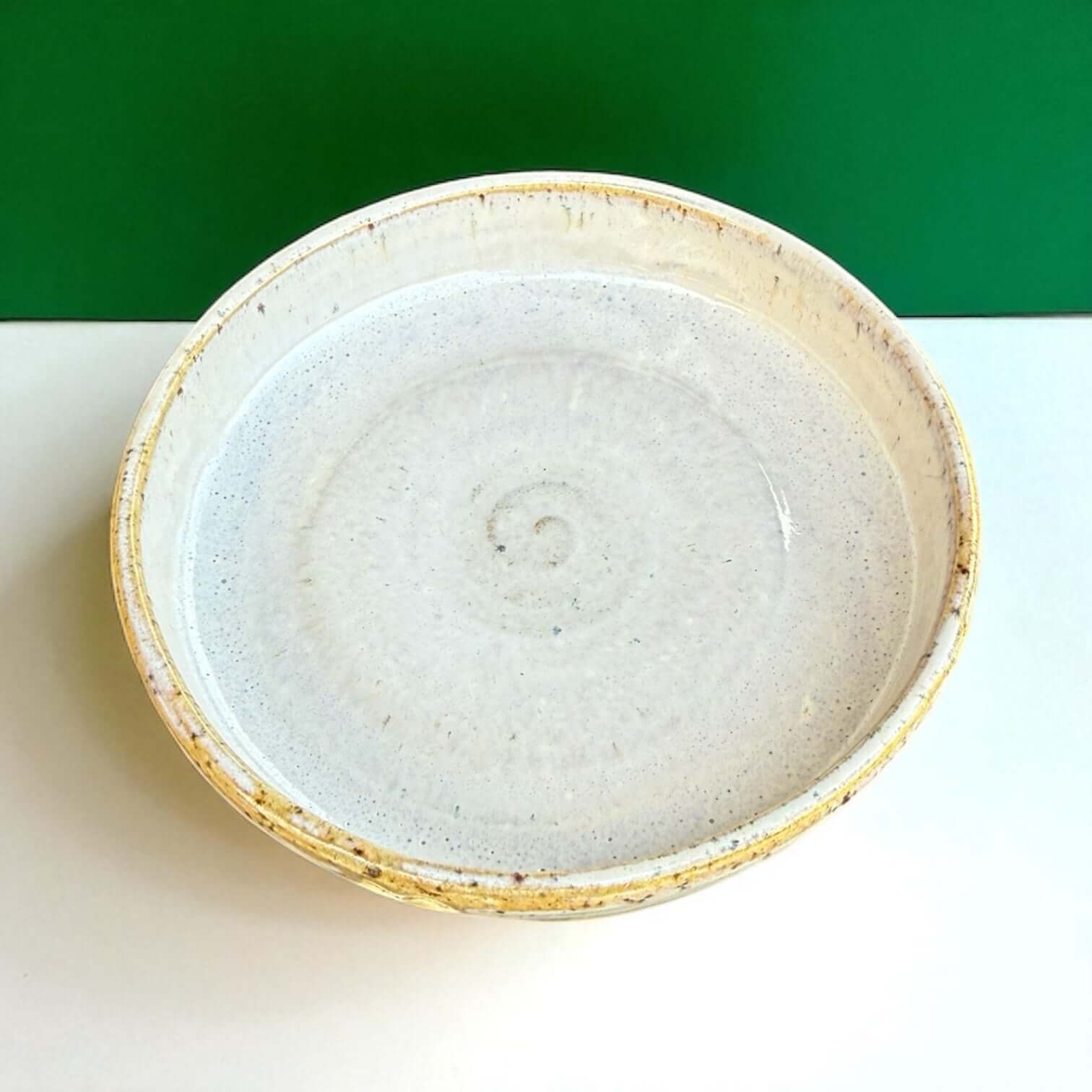 Handmade ceramic cat bowl with a speckled glaze design and embossed hearts, diameter 12 cm, suitable for food or water.