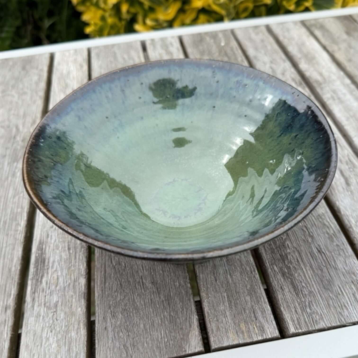 Handmade green ceramic bowl in glossy seaweed and ocean blue colors, ideal for serving salads or as home decor.