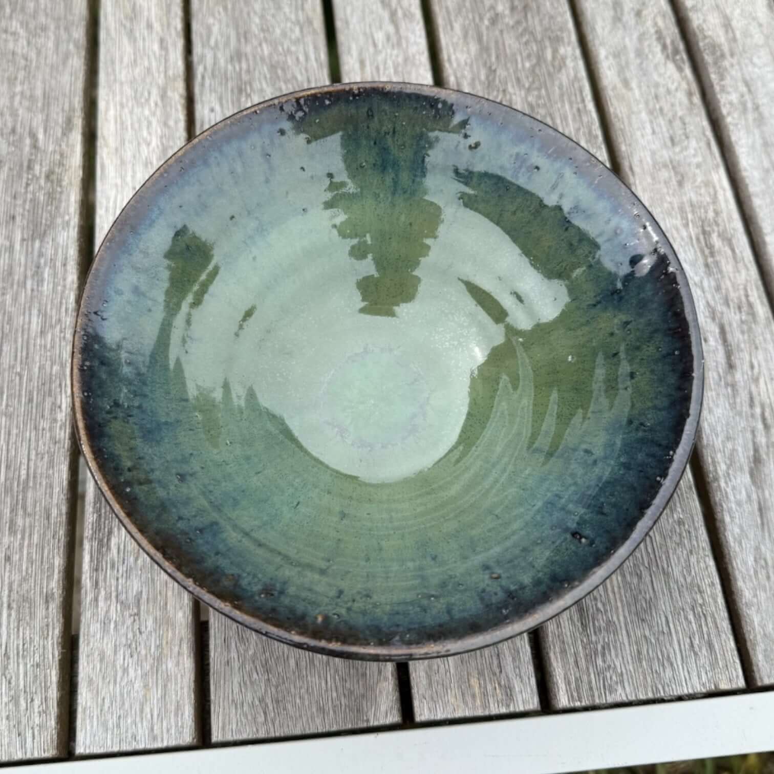 Handmade green ceramic bowl with glossy seaweed and ocean blue glaze, ideal for serving salads or as decorative home decor.