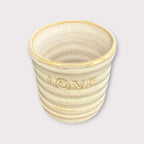 Handmade mug featuring the word 'LOVE', perfect for coffee or as a decorative item.