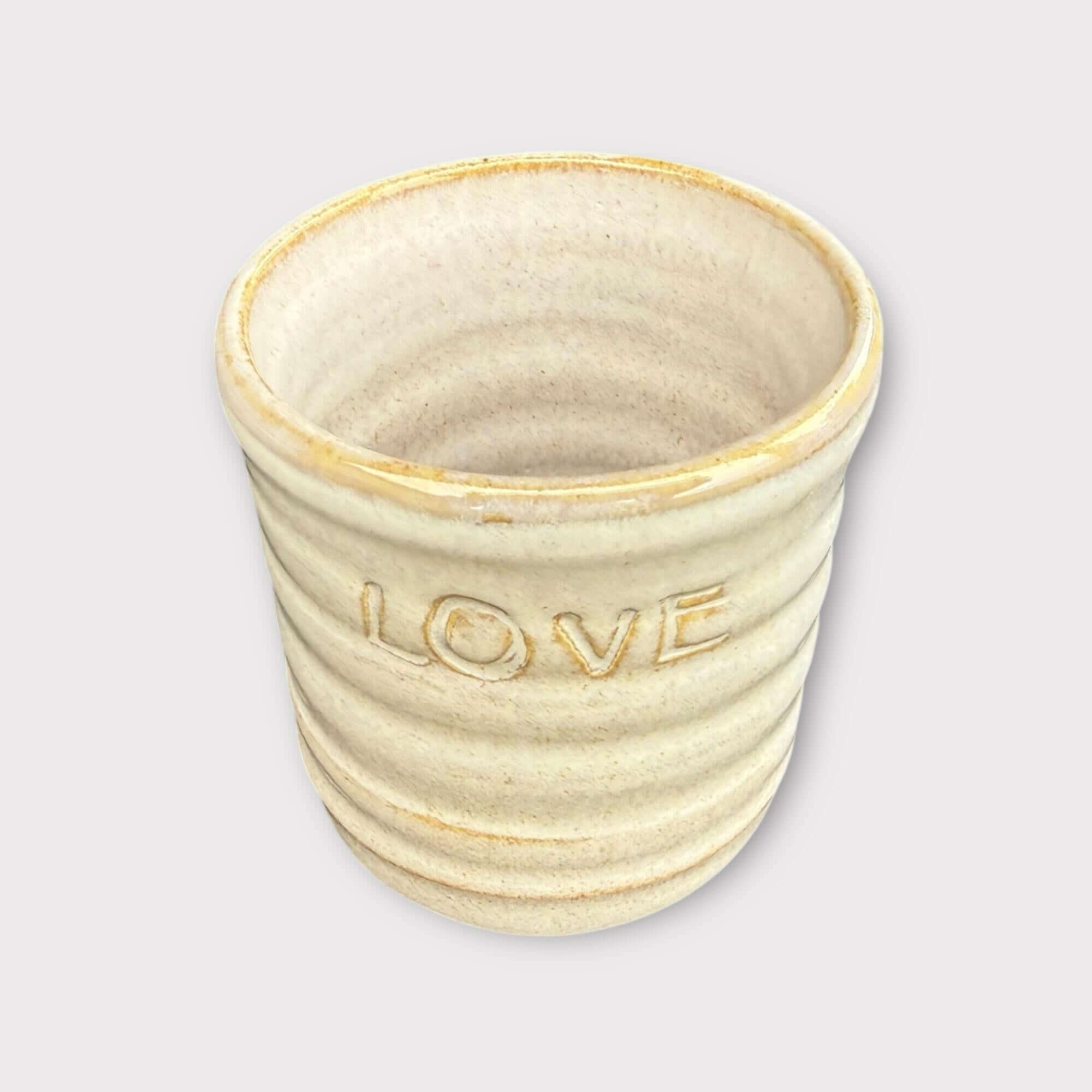 Handmade mug featuring the word 'LOVE', perfect for coffee or as a decorative item.