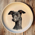Hand-painted ceramic wall plate featuring a portrait of an Italian Greyhound on a rustic wooden background.