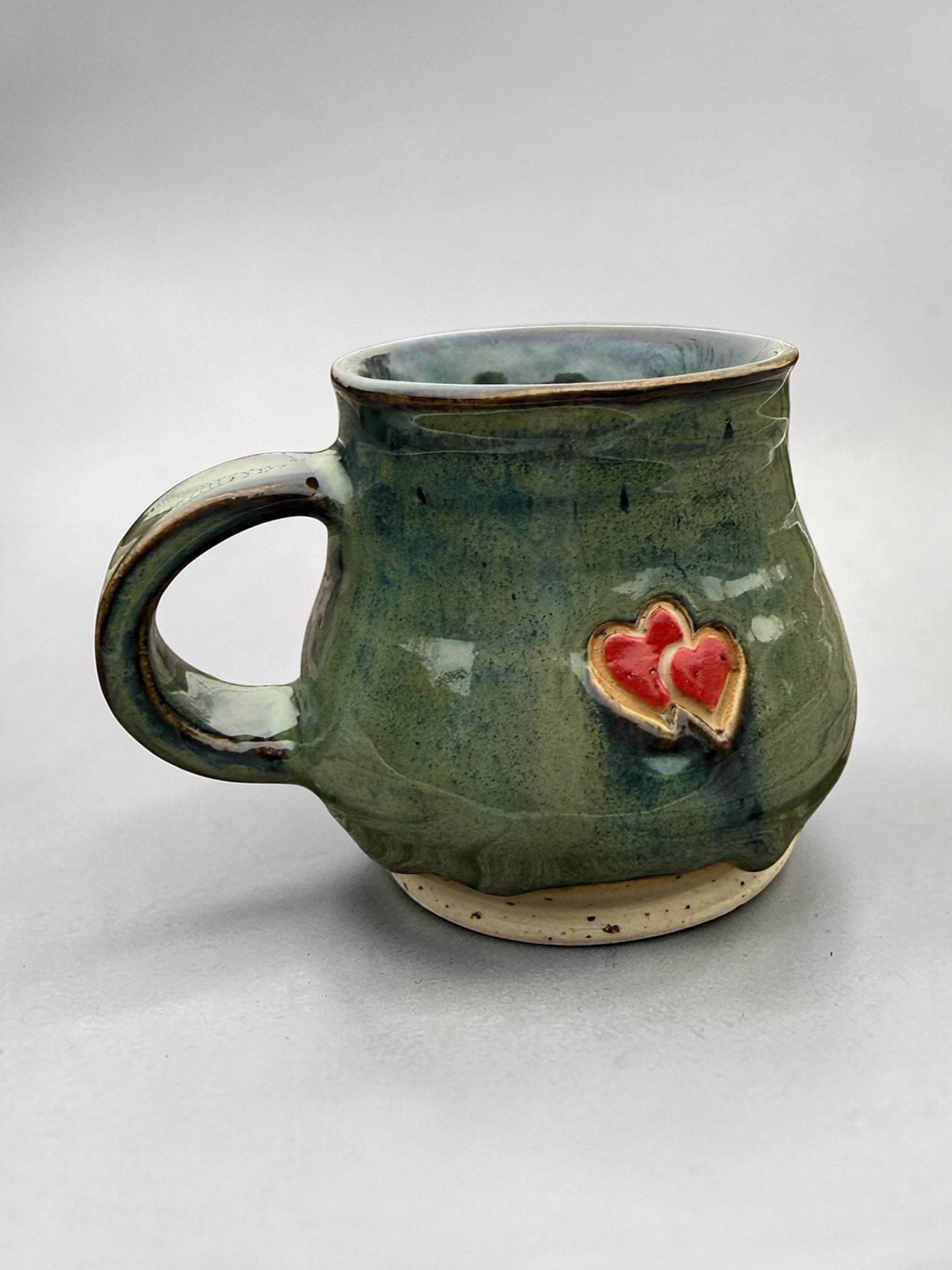 Handmade ceramic mug with hearts